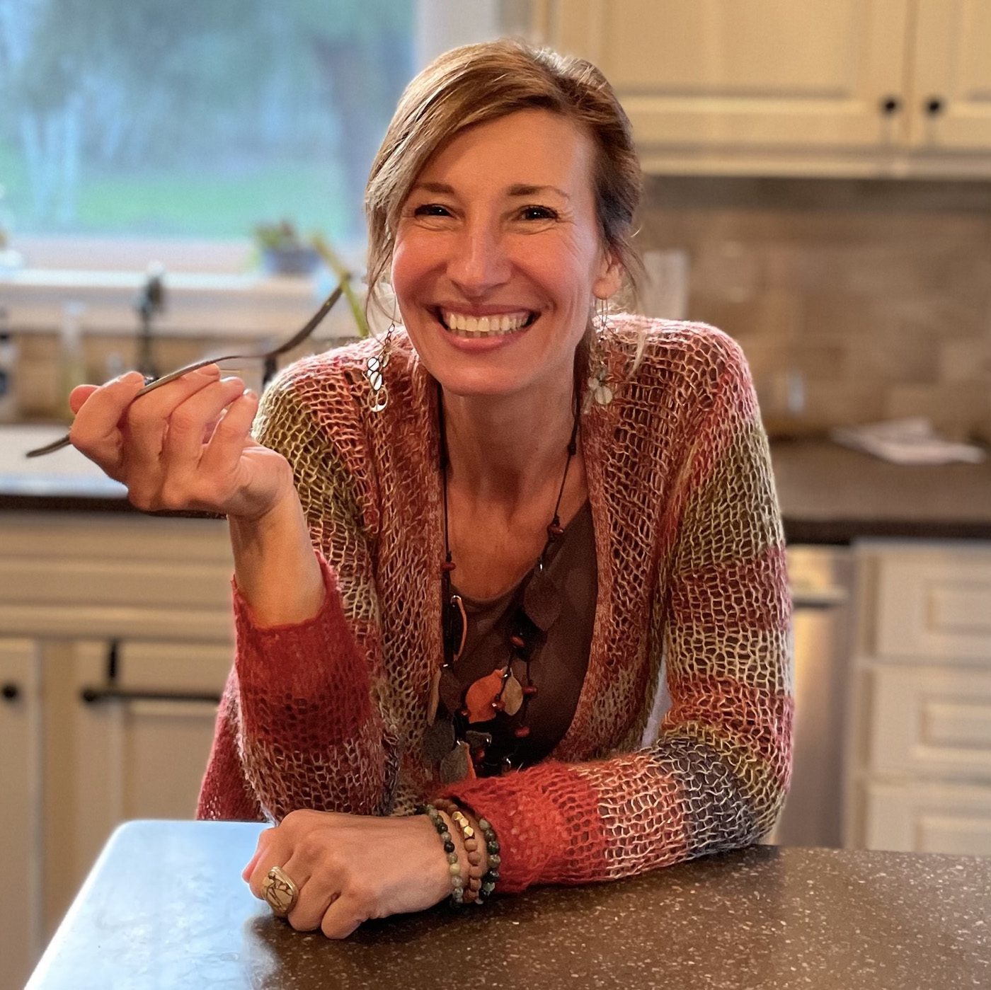 Nicole Apelian smiling and holding a fork
