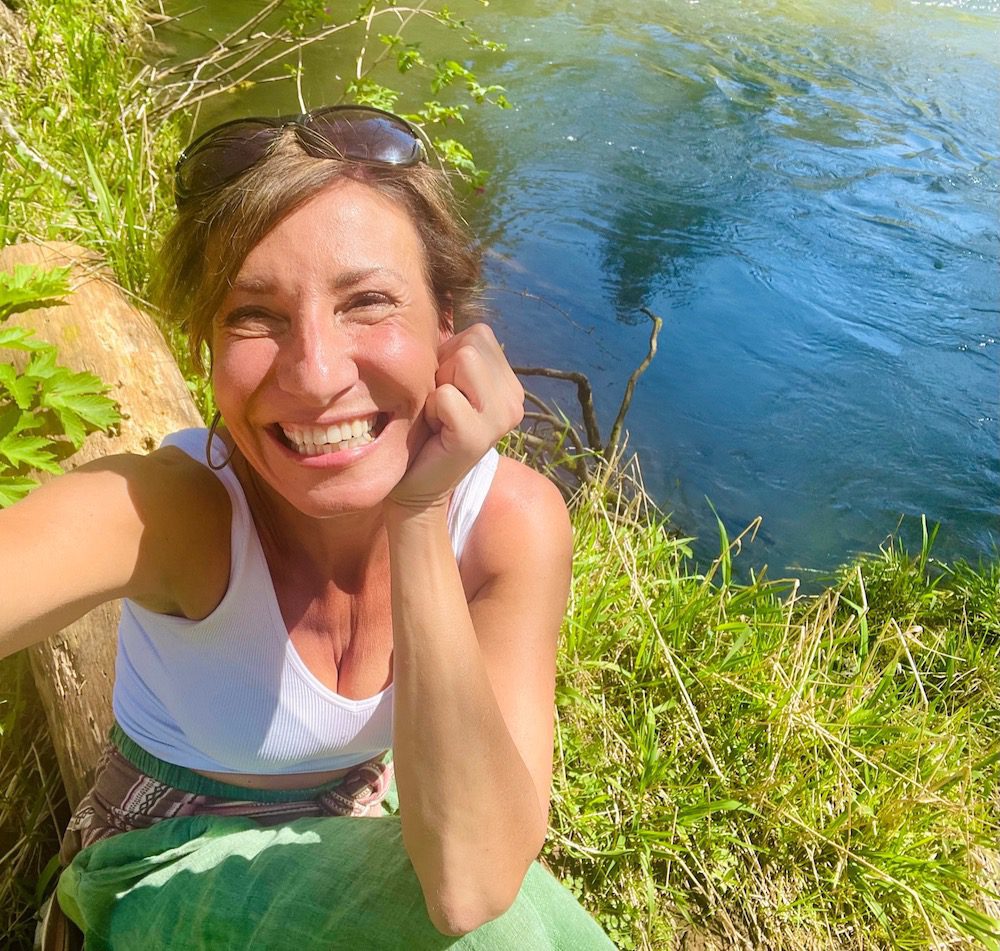 Nicole Apelian posing by a river