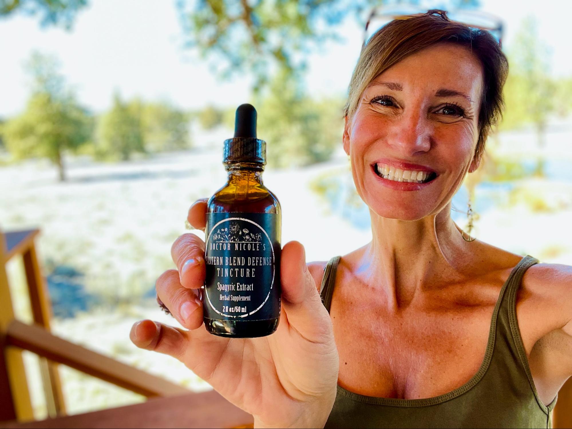 Nicole Apelian holding Eastern Blend Defense Tincture Nicole Apelian holding Eastern Blend Defense Tincture