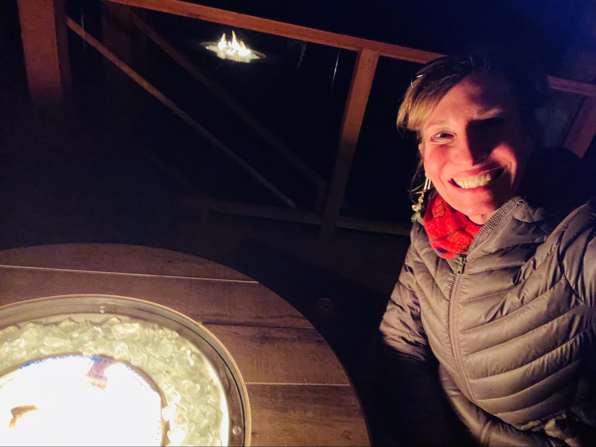 Nicole Apelian on deck at table fire pit