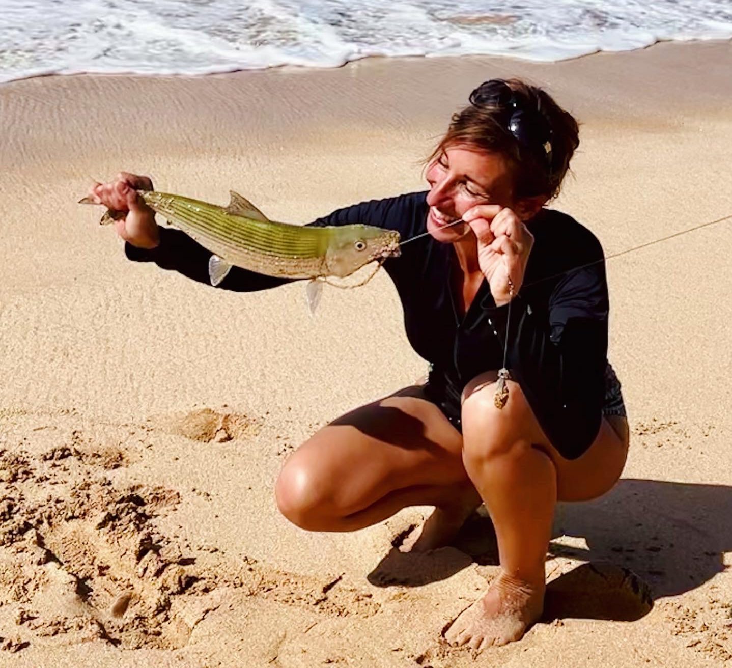 Nicole Apelian with fish on the beach