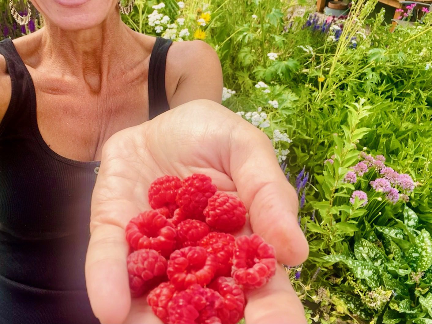 Nicole Apelian holding a handful of fresh picked raspberries