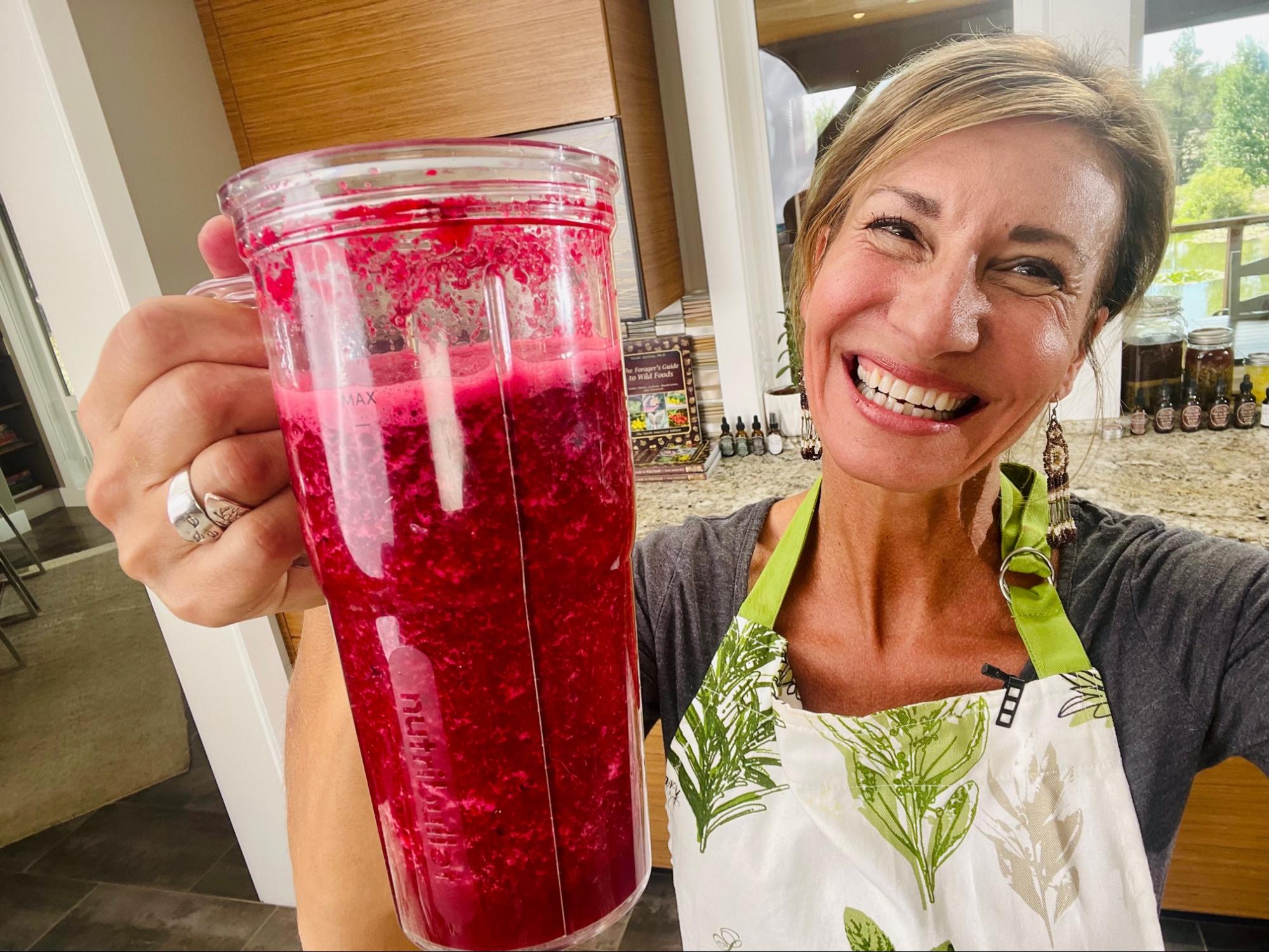 Nicole Apelian holding a blender cup of blended berries